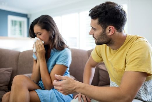 Couple arguing with each other in living room at home